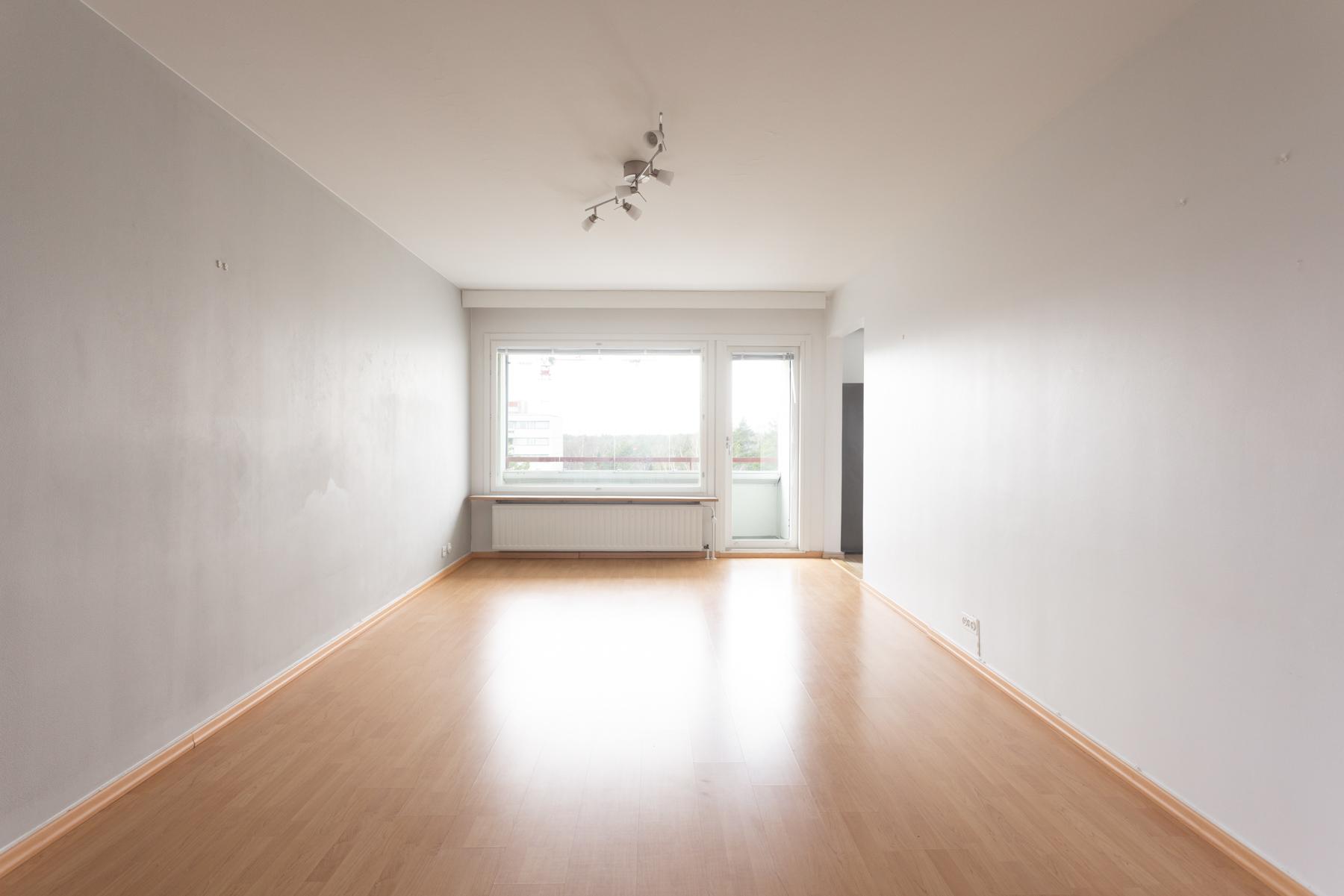 Iso valoisa olohuone - käynti lasitetulle parvekkeelle