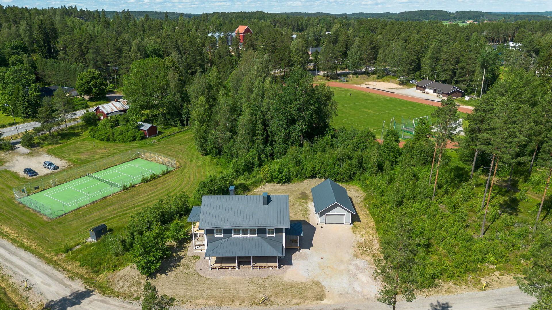 NAAPURISSA TENNIS- JA URHEILUKENTTÄ