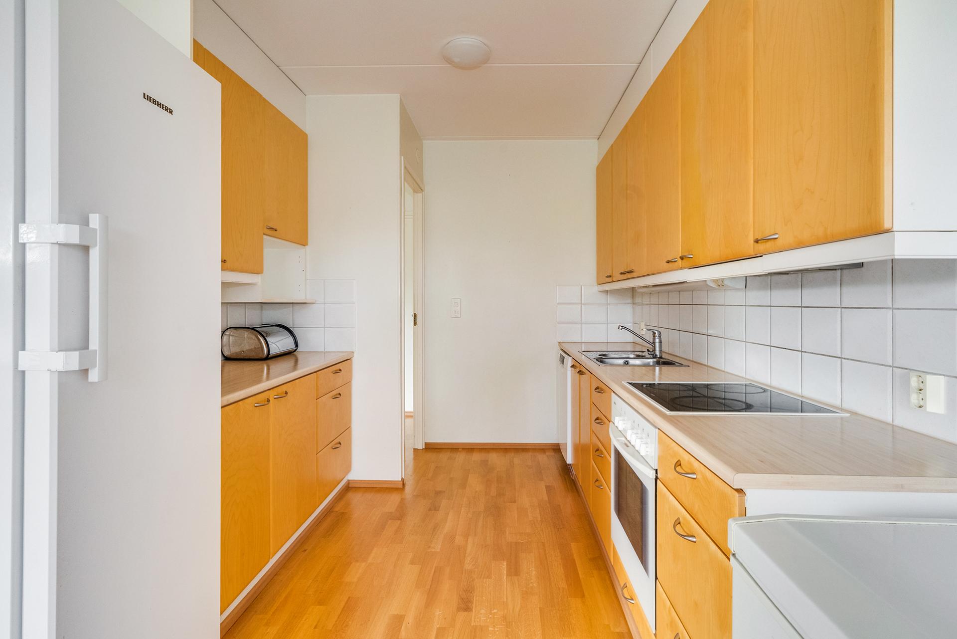 Keittiössä on hyvin kaappi- ja laskutilaa, massiivipuiset ovet