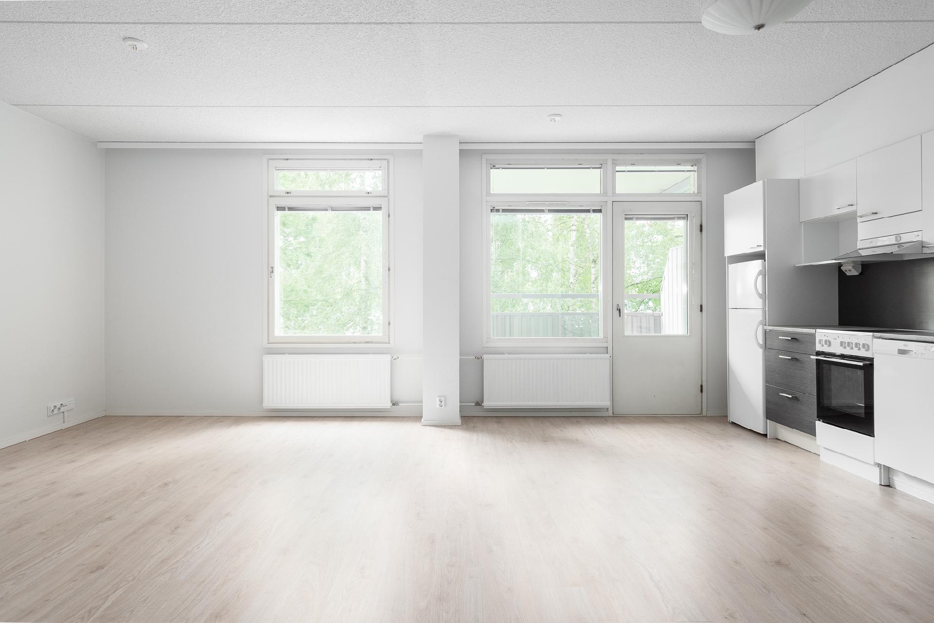 Avoin, iso, vaaleasävyinen huonetila