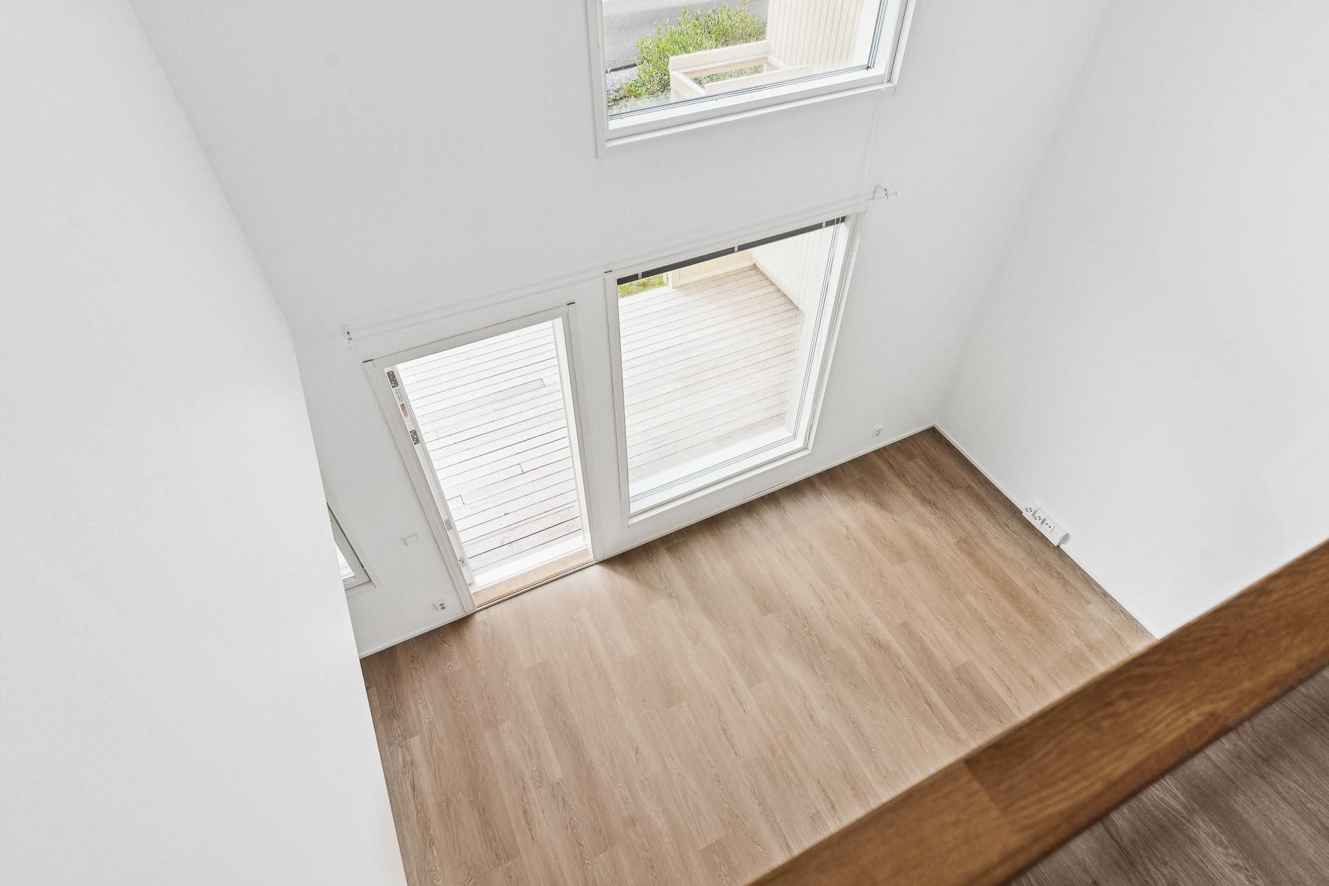 Näkymä yläkerran aulasta olohuoneeseen