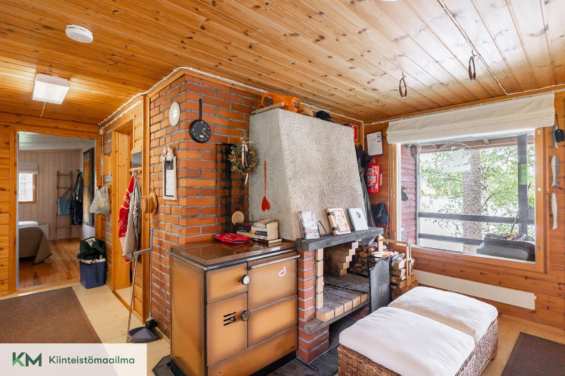 Päämökin olohuoneessa varaava takka ja Jötul-hella