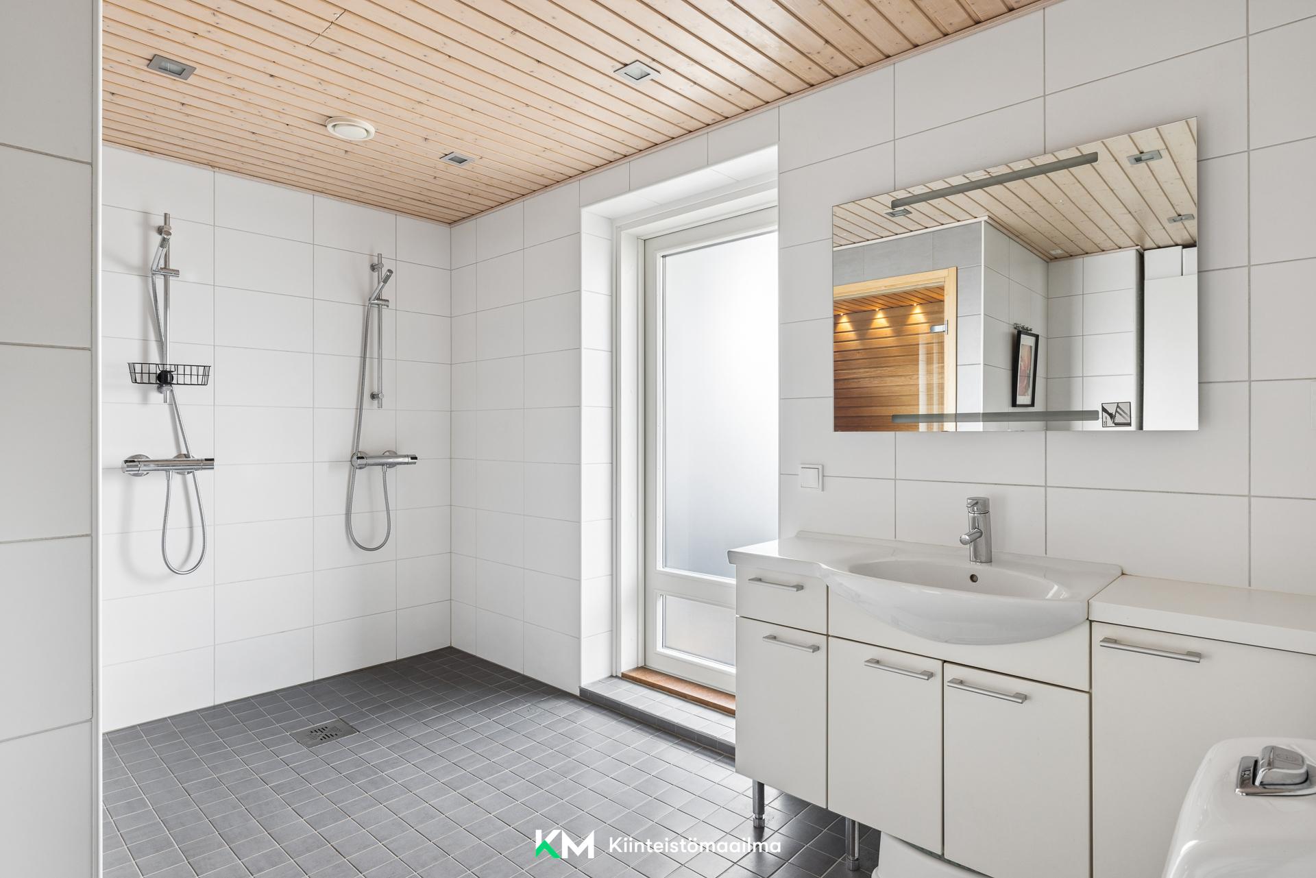 Tilava kylpyhuone, josta käynti lasitetulle parvekkeelle