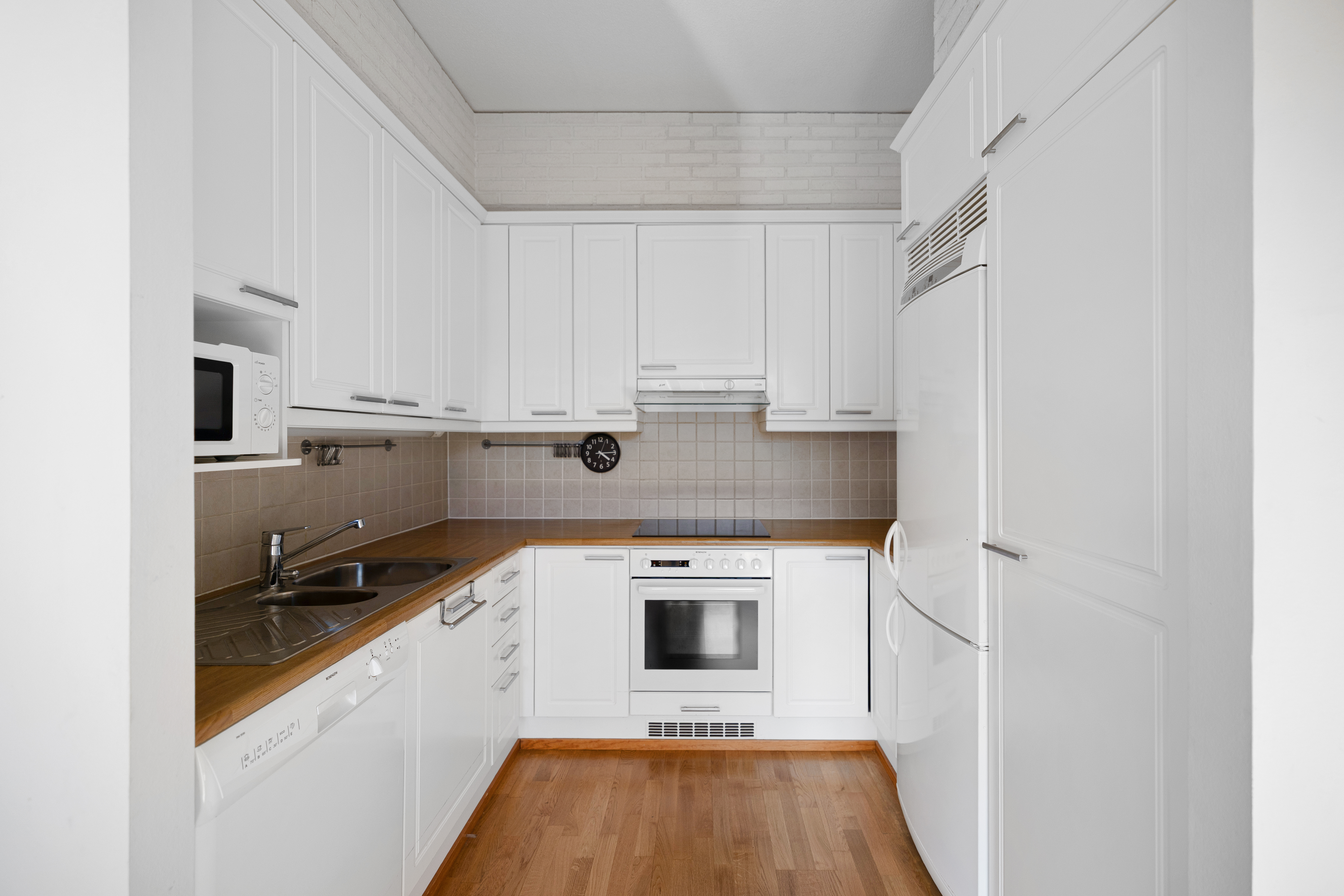 Vaalea sävyinen keittiö.