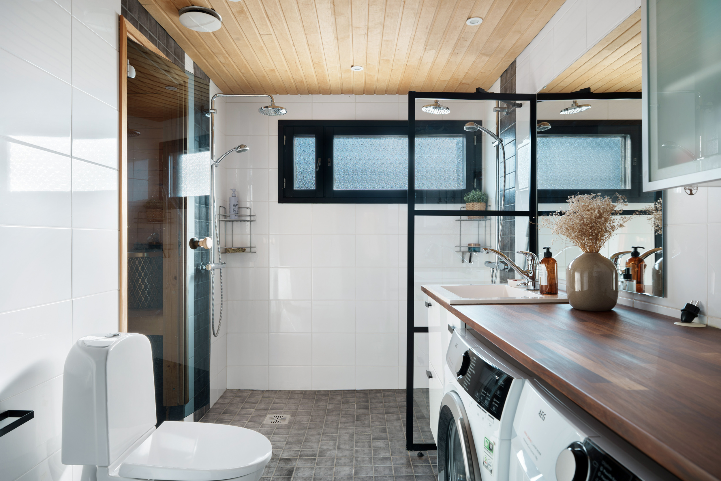 Kylpyhuoneessa vastakkain kaksi suihkua